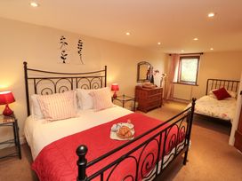 A bedroom with a double bed and a single bed at Horseshoe Cottage in Bolton Low Houses