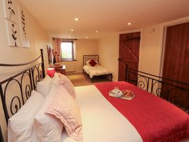 A bedroom with two beds and a tray of breakfast items at Horseshoe Cottage in Bolton Low Houses