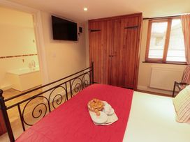A bedroom with a bed and wardrobe at Horseshoe Cottage in Bolton Low Houses