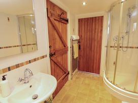 A bathroom with a sink and shower at Horseshoe Cottage in Bolton Low Houses