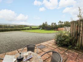 A garden with seating and playground equipment at Horseshoe Cottage in Bolton Low Houses