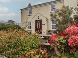 A house with a front door and garden at Garth Cottage in Haverfordwest