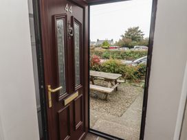 An entrance with a door and a bench outside at Garth Cottage Haverfordwest