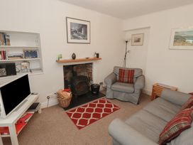 A living room with a sofa and armchair at Garth Cottage in Haverfordwest