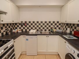 A kitchen with appliances and cabinets at Garth Cottage in Haverfordwest