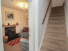 A living room with a sofa and fireplace at Garth Cottage in Haverfordwest