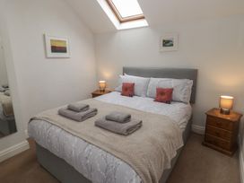 A bedroom with a double bed and nightstands at Garth Cottage in Haverfordwest