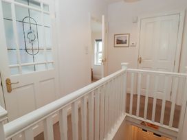 A hallway with a door and window at Garth Cottage in Haverfordwest