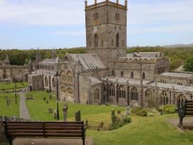 A cathedral and graveyard with a tower and pathway at Garth Cottage Haverfordwest