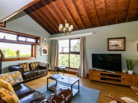 A living room with a sofa and table at Boathouse in Deganwy near Llandudno