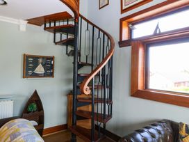 A spiral staircase and window in a living room at Boathouse in Deganwy near Llandudno