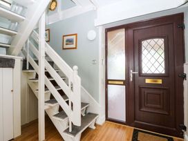 A hallway with stairs and a front door at Boathouse in Deganwy near Llandudno