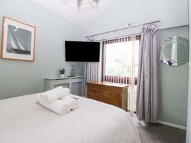 A bedroom with a bed and television at Boathouse in Deganwy near Llandudno