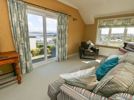 A living room with a view and furniture at Bryn y Don in Benllech
