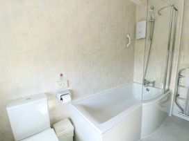 A bathroom with a bathtub and shower at Bryn y Don in Benllech