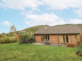 A building with patio furniture in a garden at Geryllan near Rhandirmwyn