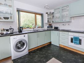 A kitchen with appliances and cabinetry at Geryllan Rhandirmwyn near Llandovery