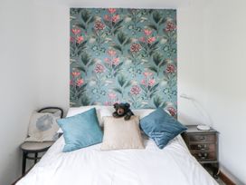 A bedroom with a bed and decorative pillows at Geryllan Rhandirmwyn near Llandovery