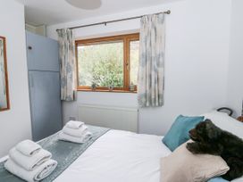 A bedroom with a bed and wardrobe at Geryllan Rhandirmwyn near Llandovery