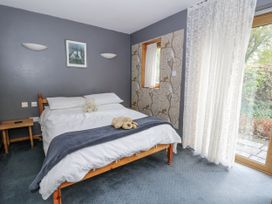A bedroom with a bed and a window at Geryllan Rhandirmwyn near Llandovery