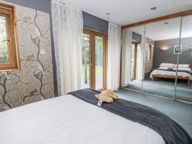 A bedroom with a view of the garden at Geryllan Rhandirmwyn near Llandovery