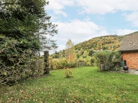 A garden with grass and trees at Geryllan Rhandirmwyn near Llandovery