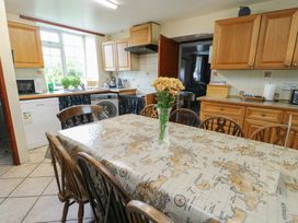 A kitchen with a table and chairs at Glan y Gors in Dinorwic near Llanberis