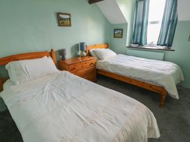 A bedroom with two beds and a window at Glan y Gors Dinorwic near Llanberis