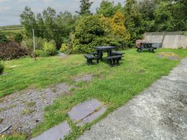 A garden with a table and benches at Glan y Gors Dinorwic near Llanberis