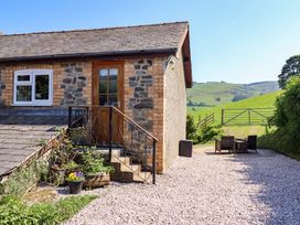 An outdoor area with steps leading to a door at Peniarth in Penybontfawr near Oswestry