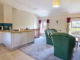 A living room with kitchen area and furniture at Peniarth in Penybontfawr near Oswestry
