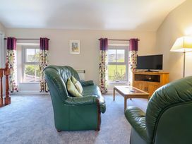 A living room with a sofa and television at Peniarth in Penybontfawr near Oswestry