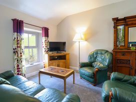 A living room with a sofa and coffee table at Peniarth in Penybontfawr near Oswestry