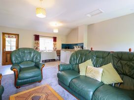 A living room with green sofas and a coffee table at Peniarth in Penybontfawr near Oswestry