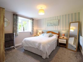 A bedroom with a bed and nightstand at Peniarth in Penybontfawr near Oswestry