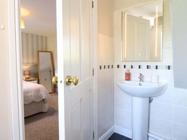 A bathroom with a sink and mirror at Peniarth in Penybontfawr near Oswestry
