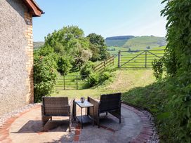 A garden with patio furniture and a view of fields at Peniarth in Penybontfawr near Oswestry