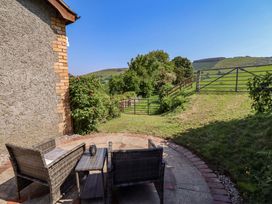 An outdoor area with chairs and a table at Peniarth in Penybonfawr near Oswestry