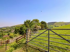 A view of hills and trees with a gate in the foreground at Peniarth in Penybontfawr near Oswestry