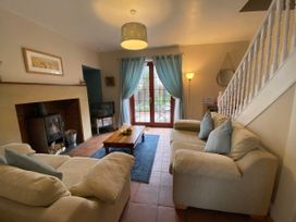 A living room with a fireplace and television at Sea Lily New Haggerston near Holy Island