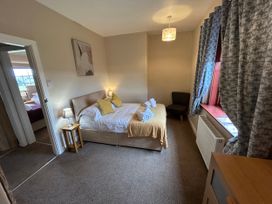 A bedroom with a bed and bedside table at Sea Lily New Haggerston near Holy Island