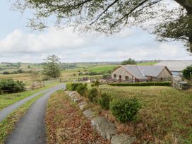 An outdoor view of a building with fields and trees at Y Bwthyn in Swyddffynnon near Pontrhydfendigaid