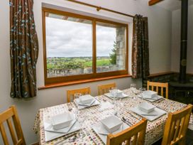 A dining room with a table set for meals at Y Bwthyn in Swyddffynnon near Pontrhydfendigaid