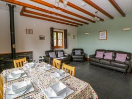 A dining room with a table set for dinner and a sofa at Y Bwthyn in Swyddffynnon near Pontrhydfendigaid