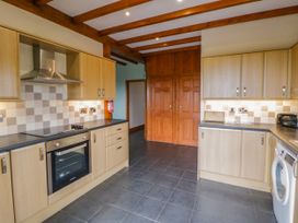 A kitchen with cabinets and appliances at Y Bwthyn in Swyddffynnon near Pontrhydfendigaid