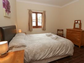 A bedroom with a double bed and wooden furniture at Y Bwthyn in Swyddffynnon near Pontrhydfendigaid