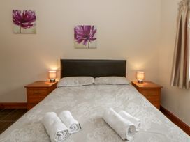 A bedroom with a bed and nightstands at Y Bwthyn in Swyddffynnon near Pontrhydfendigaid