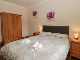 A bedroom with a bed and wardrobe at Y Bwthyn near Pontrhydfendigaid