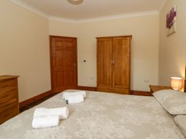 A bedroom with a bed and wooden furniture at Y Bwthyn in Swyddffynnon near Pontrhydfendigaid