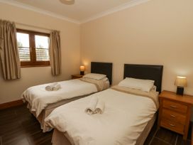A bedroom with two single beds and a bedside table at Y Bwthyn in Swyddffynnon near Pontrhydfendigaid